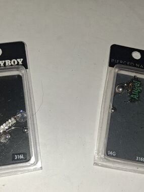 2 Playboy-branded belly button ring in blister packaging